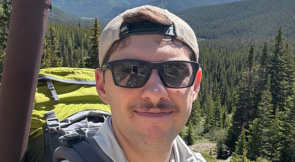 Braydon closeup with mountains in the background