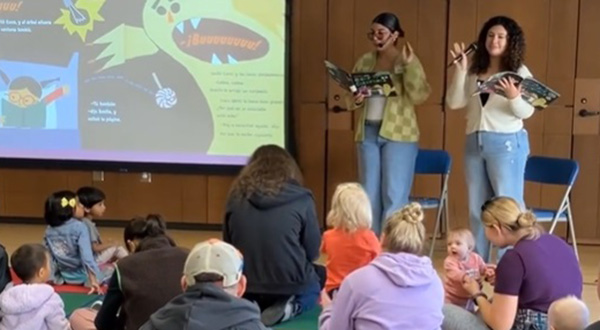 students read to children and families and show slides of book pages
