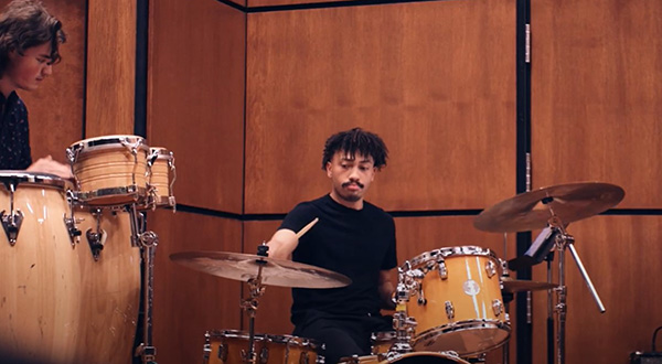 Devon playing drum set