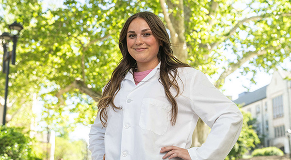 Maggie posed outdoors in medical white coat