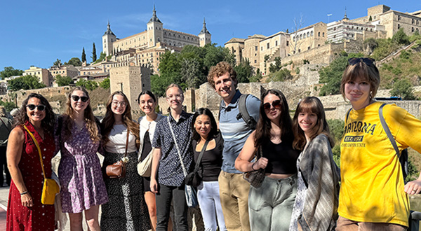 group posed in front of castle