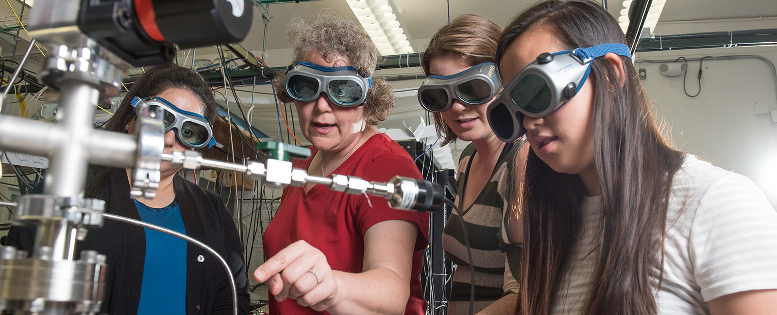 A professor demonstrates a physics experiment to students