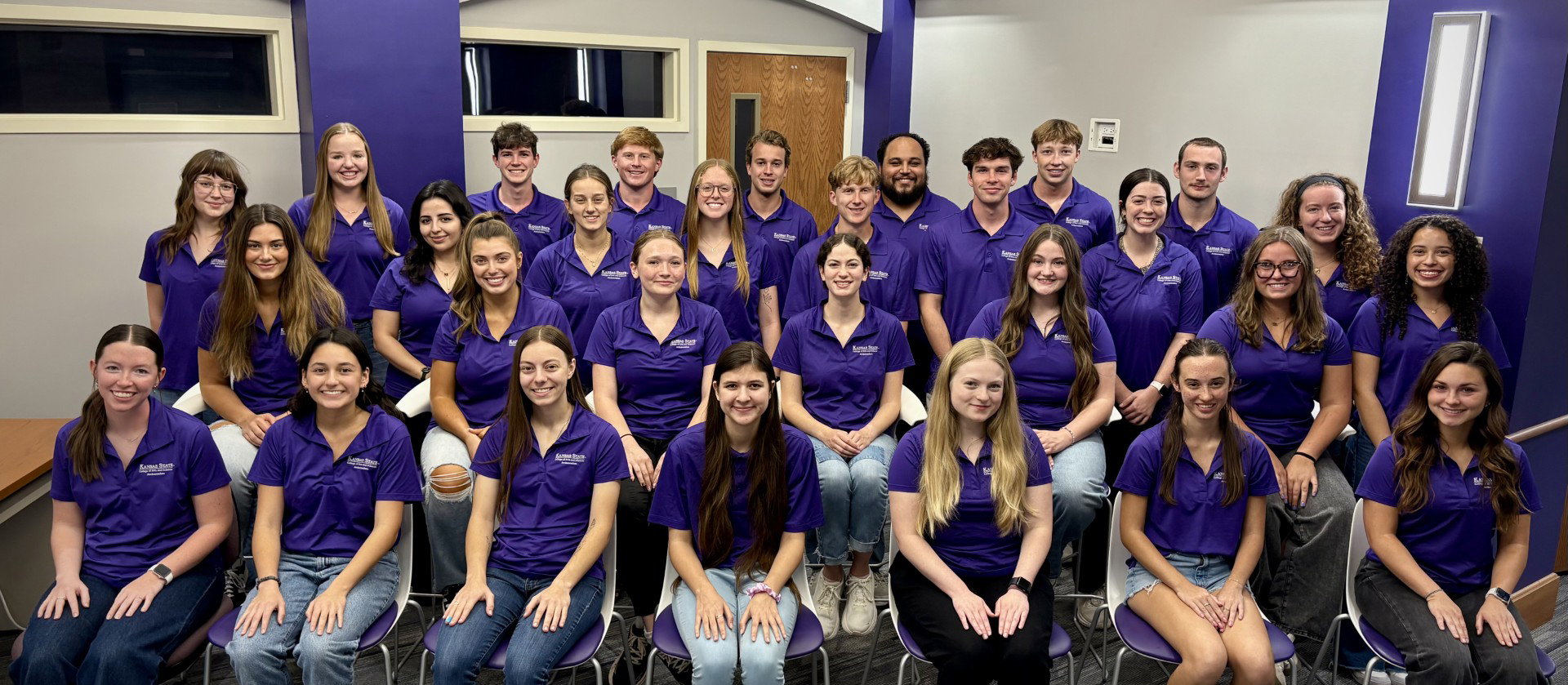 Student Ambassadors pose for photo, most in purple branded polo shirts